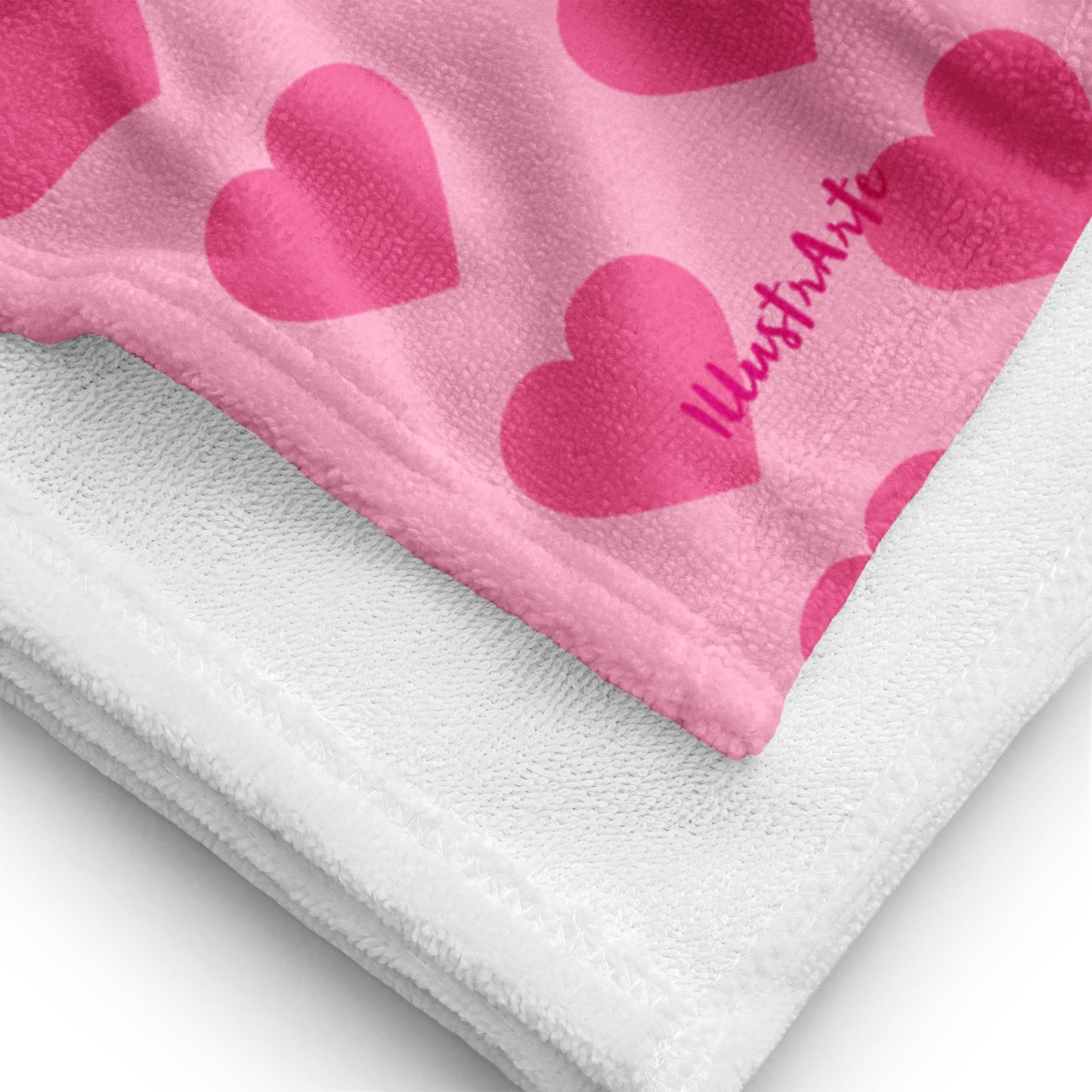 a pink and white blanket with hearts on it