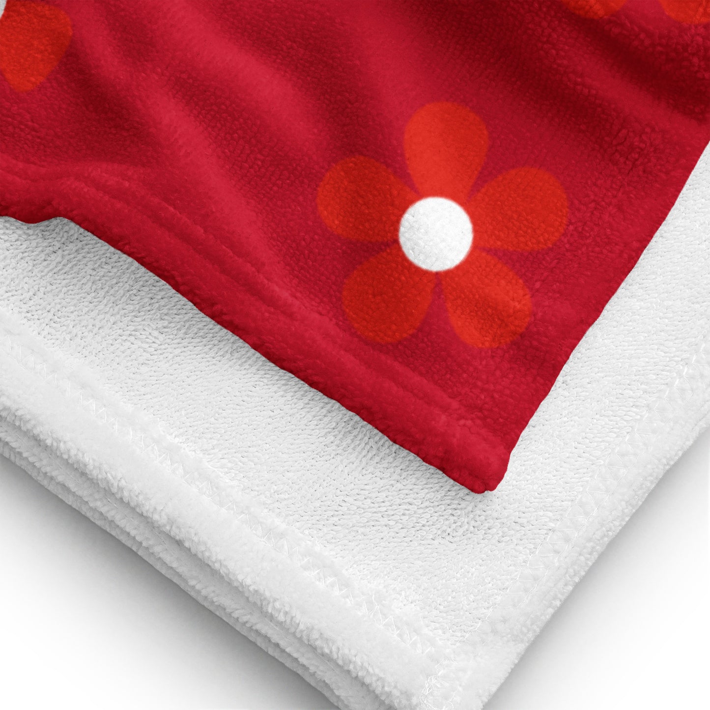 a red and white towel with a flower on it