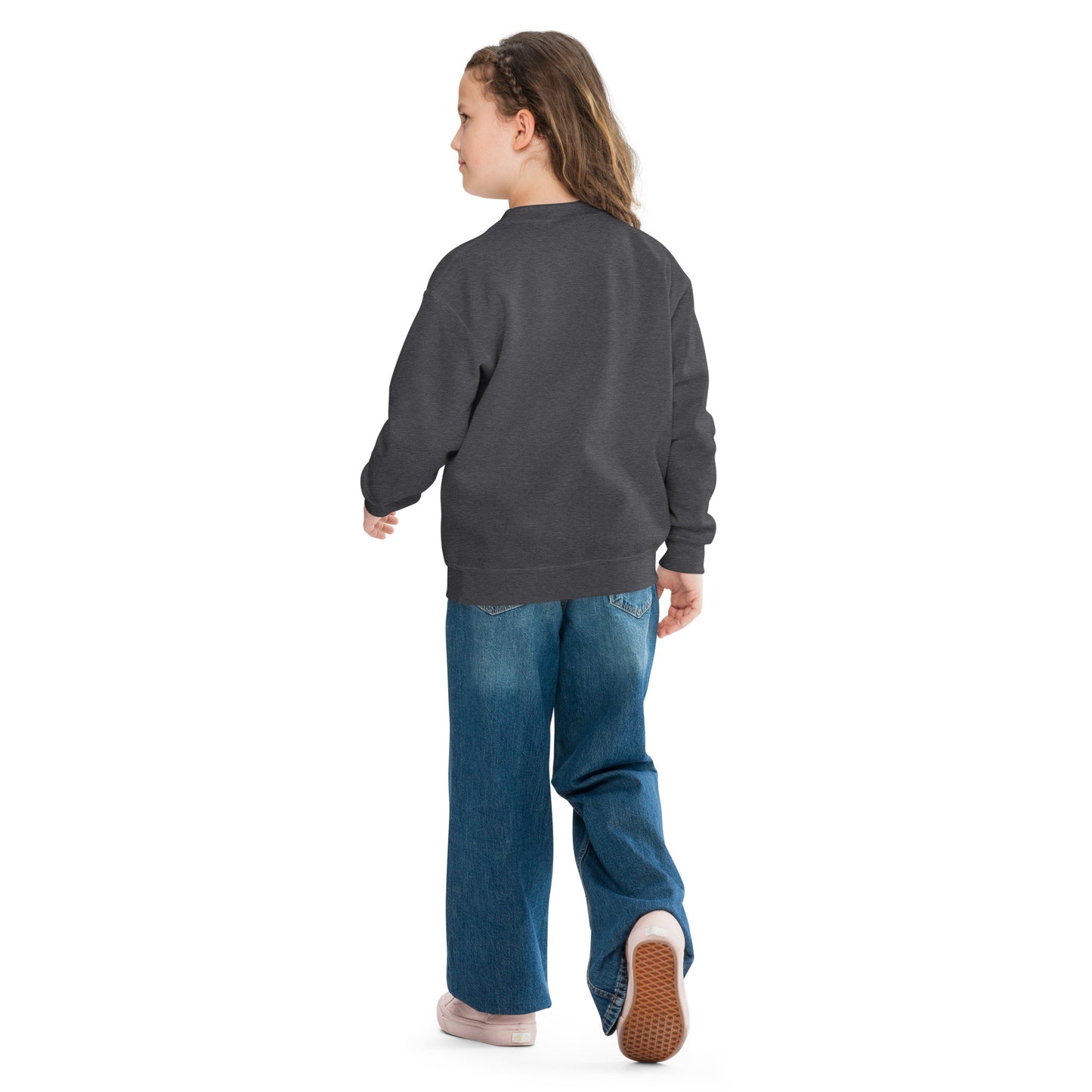 a little girl wearing a sweatshirt and jeans