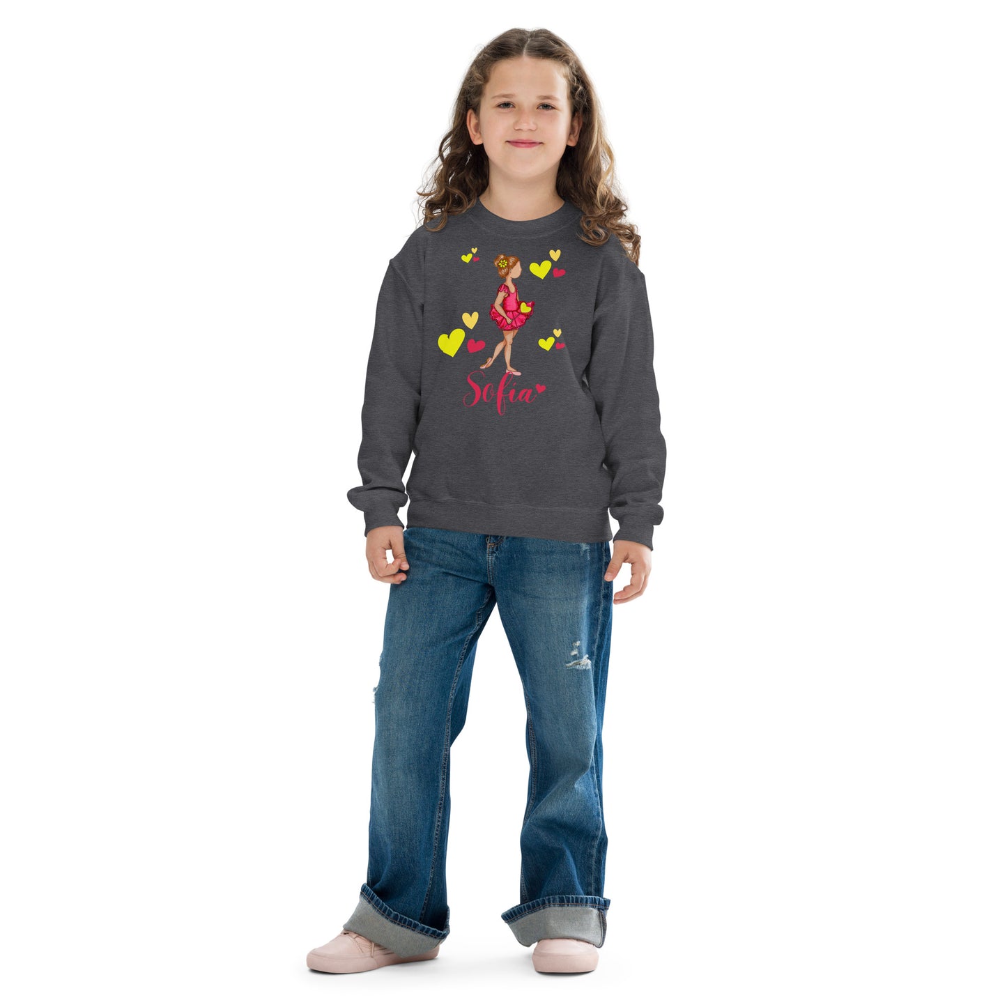 a young girl wearing a sweatshirt and jeans