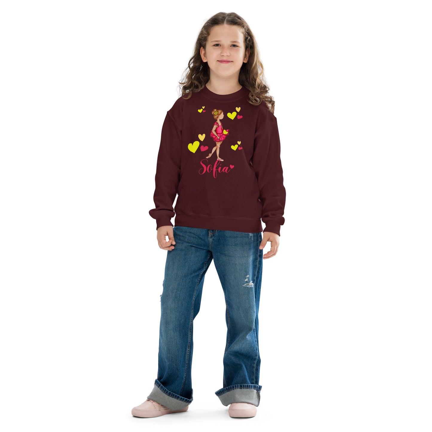 a young girl wearing a maroon sweatshirt with hearts on it