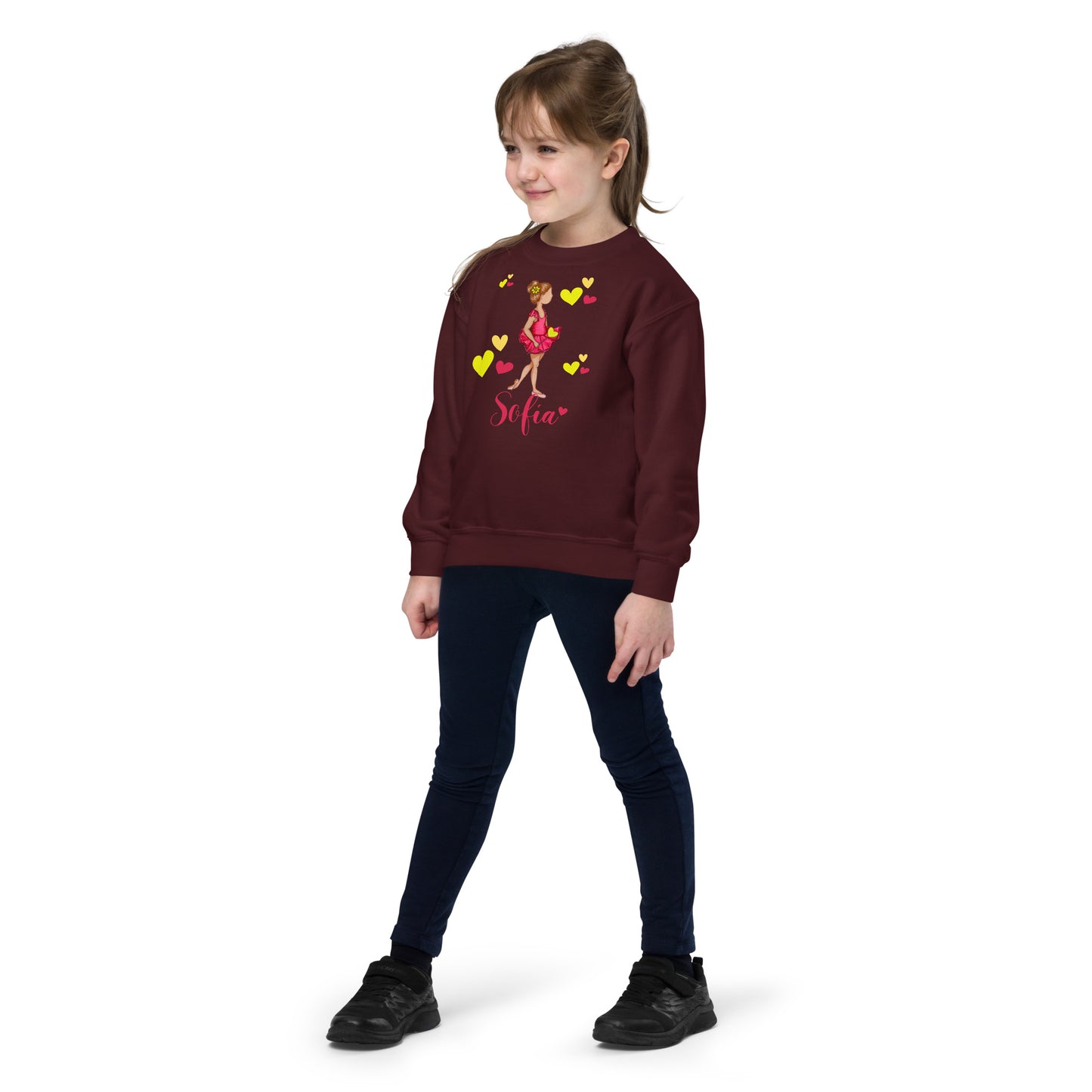 a young girl wearing a red sweatshirt and jeans