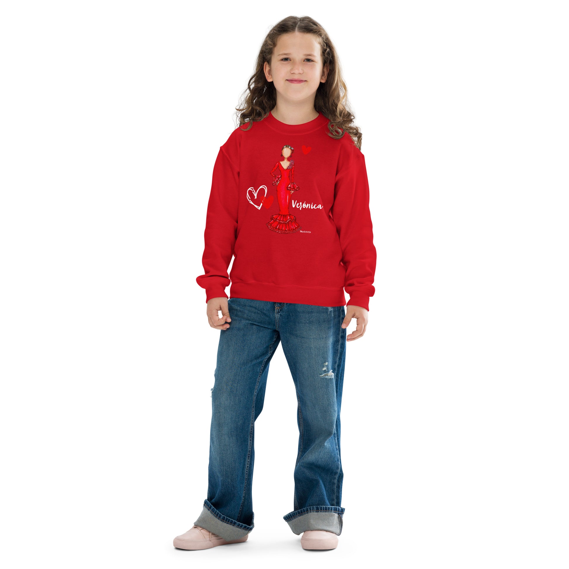 a young girl wearing a red sweatshirt and jeans
