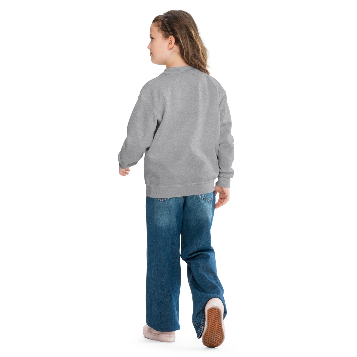 a little girl wearing a grey sweatshirt and jeans