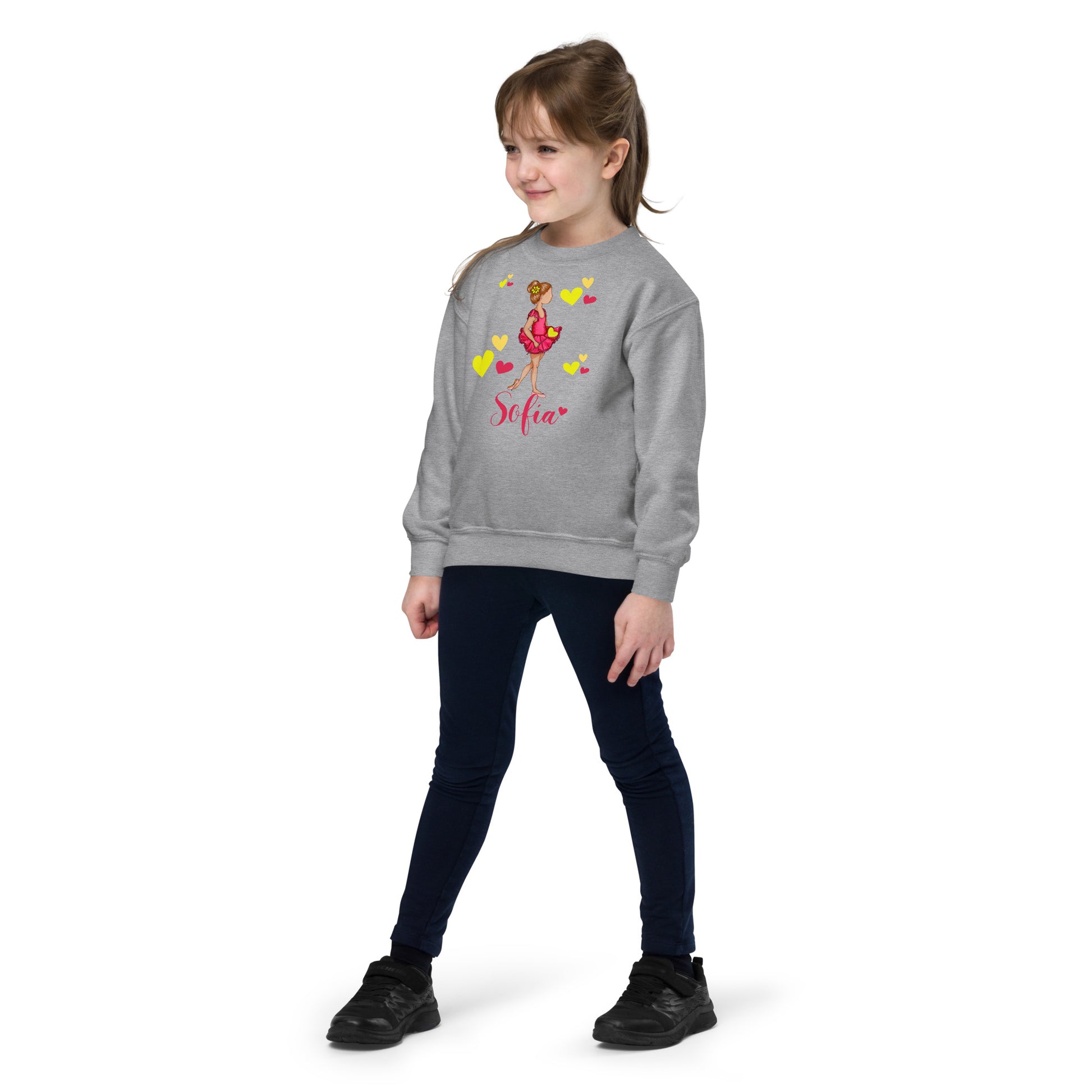 a little girl wearing a sweatshirt with a flower on it