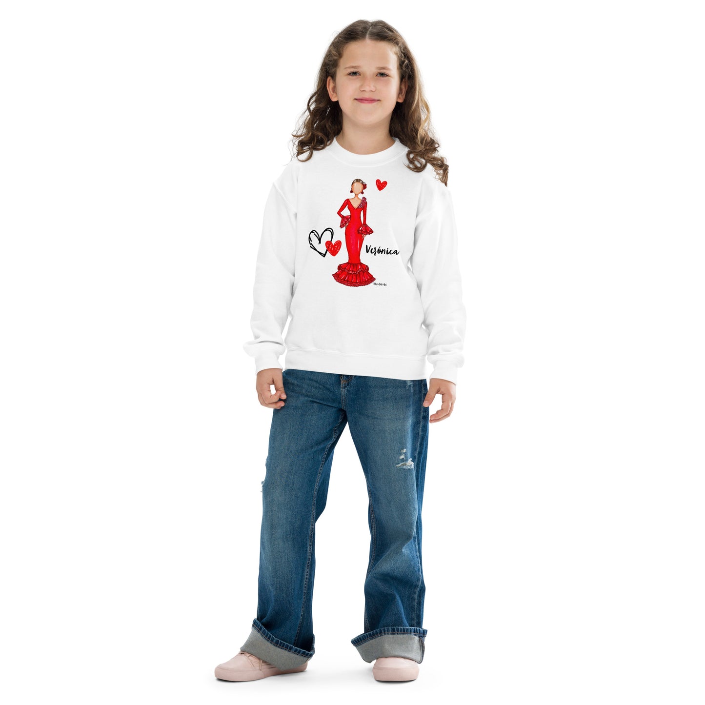 a little girl wearing a white sweater with a red heart on it